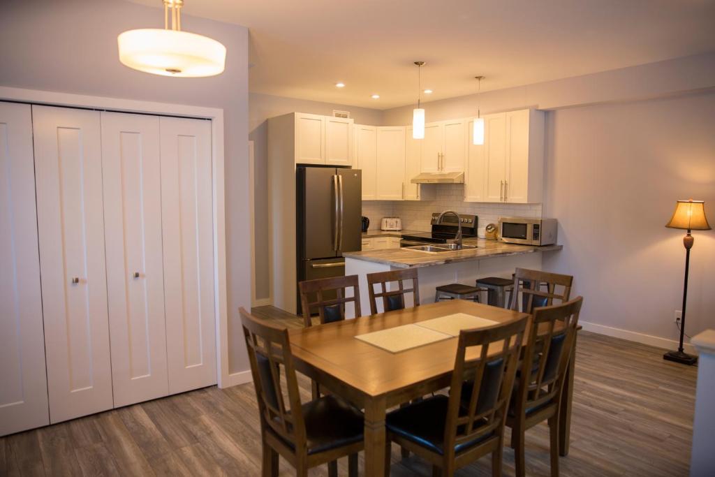 a kitchen and dining room with a table and chairs at Downtown Whitehorse 4 bedrooms deluxe condo in Whitehorse