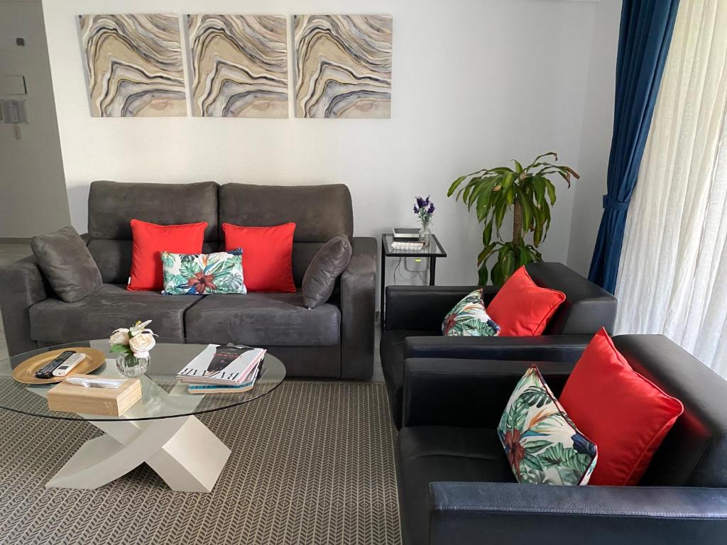 a living room with two couches and a table at Apartamento Parque Alameda in Marbella
