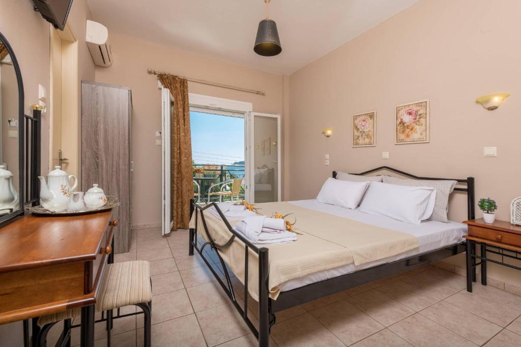 a bedroom with a bed and a desk and a window at Dimitreli Eleni Studios in Koinyra