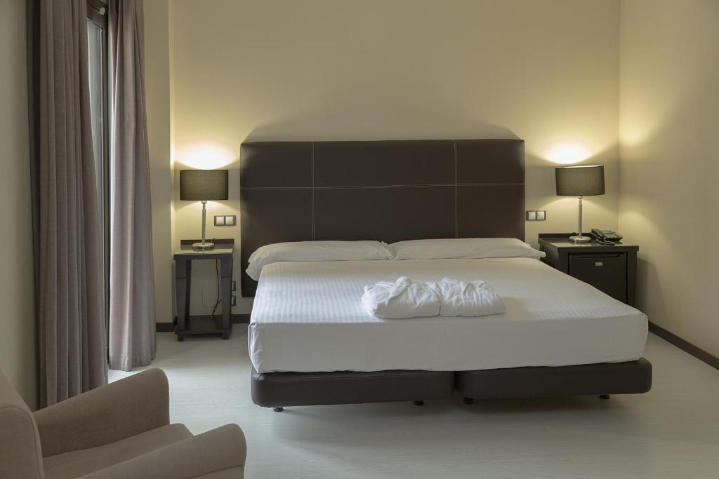 Posteľ alebo postele v izbe v ubytovaní Hotel Real Balneario Carlos III