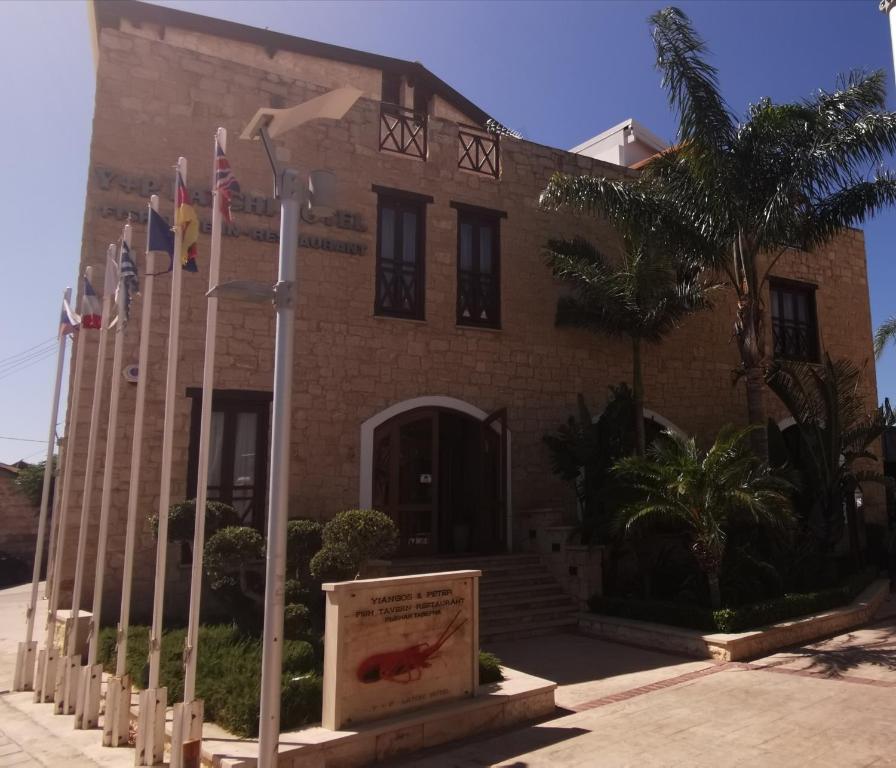 a building with a sign in front of it at Y & P LATCHI HOTEL in Lachi