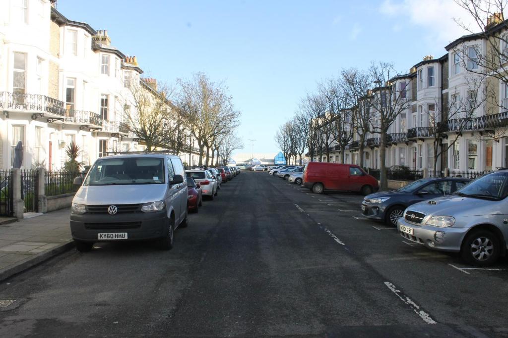 a street with cars parked on the side of the road at Seahorse Guest House in Great Yarmouth