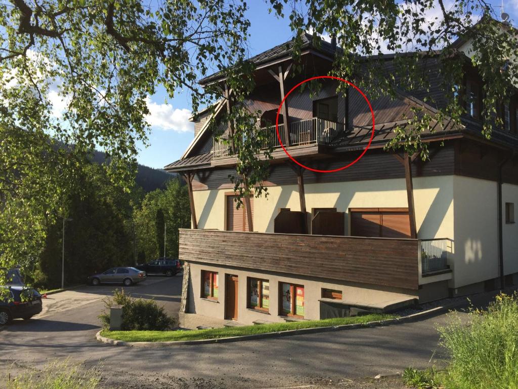 a house with a red circle on the side of it at Apartman U sjezdovky in Velké Karlovice