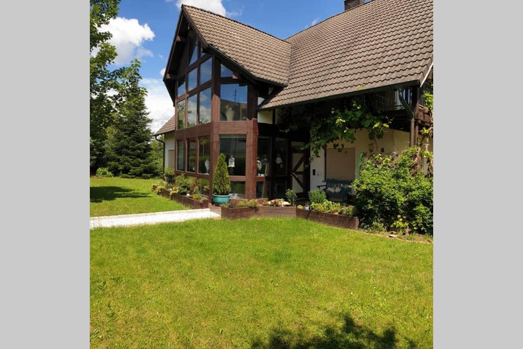 a house with a large lawn in front of it at An den Auwiesen in Kleineicholzheim