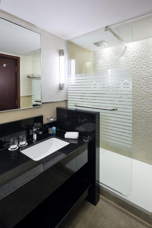 a bathroom with a sink and a shower at Saja Al Madinah in Al Madinah