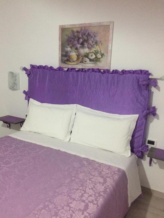 Postel nebo postele na pokoji v ubytování Casa Violet per Civita