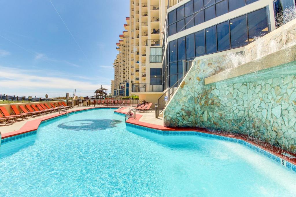 a large swimming pool next to a building at Phoenix Vacation Rentals in Orange Beach