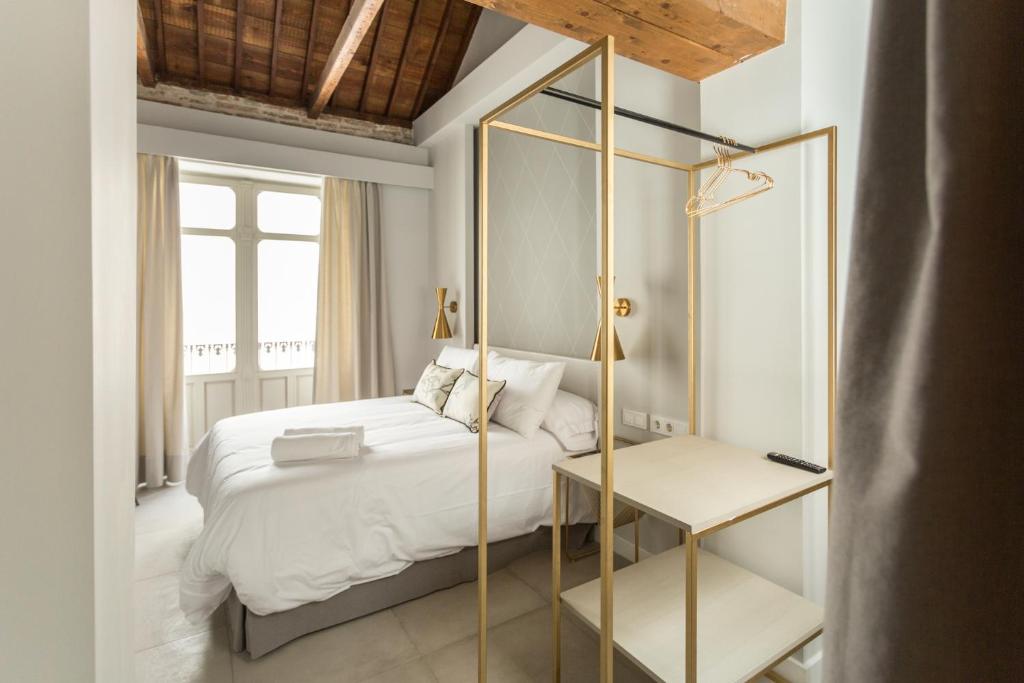 a bedroom with a white bed and a mirror at W Thyssen house in Málaga