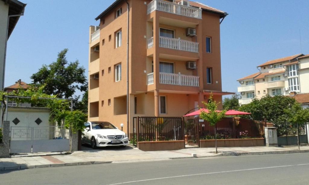 a building with a car parked in front of it at Петкови Лозенец in Lozenets