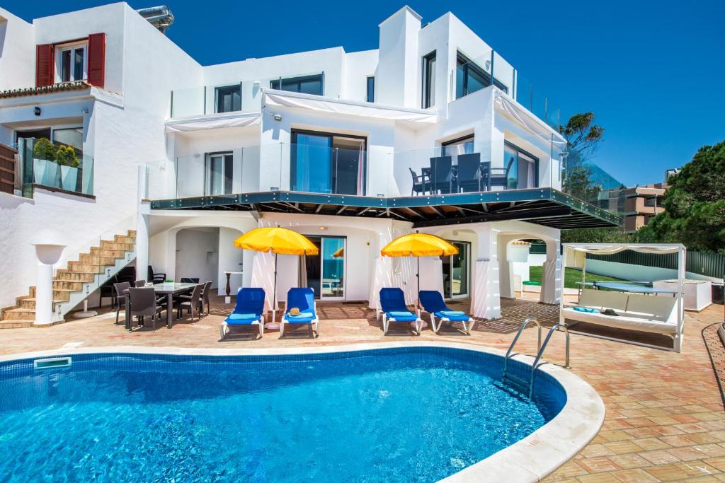 a villa with a swimming pool and a house at Forte São João Villas da Praia in Albufeira