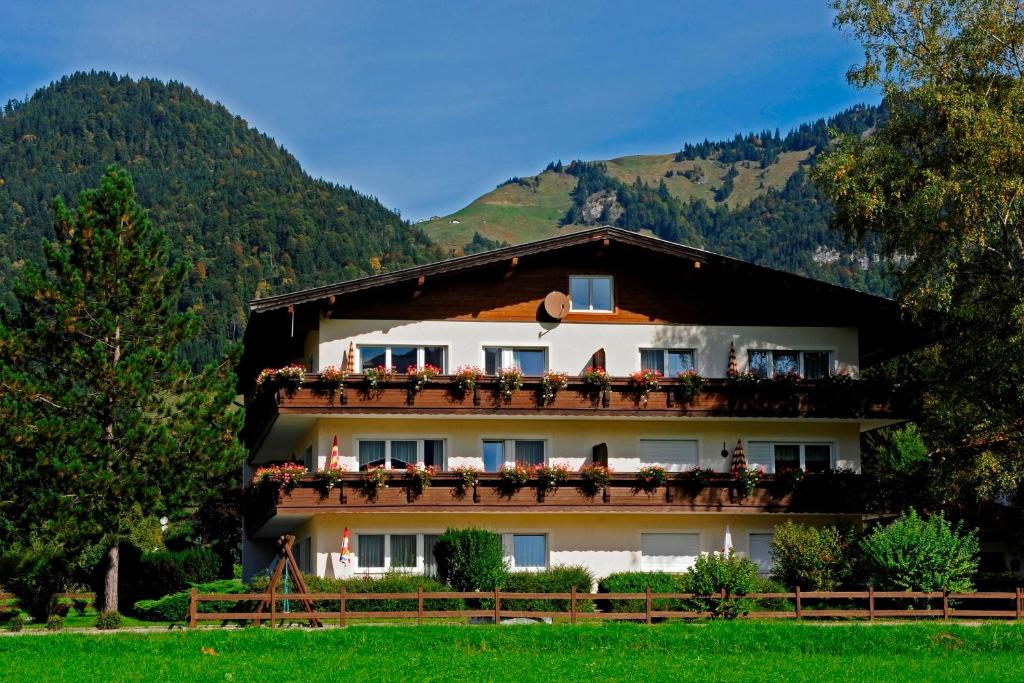 a building with flowers on the balconies of it at Tirolerhaus in Walchsee