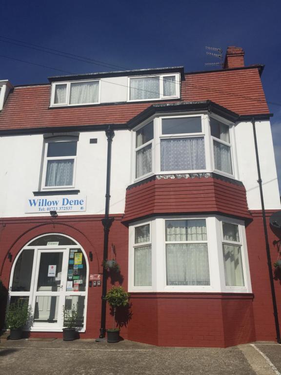 a red and white building with a window desire at Willow Dene in Scarborough