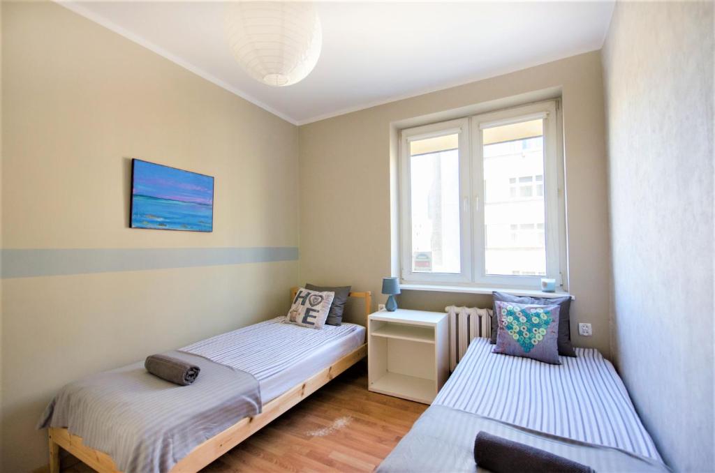 Posteľ alebo postele v izbe v ubytovaní Apartament Batory