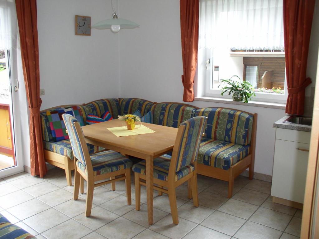 a living room with a table and a couch at Haus Waldfriede in Pertisau