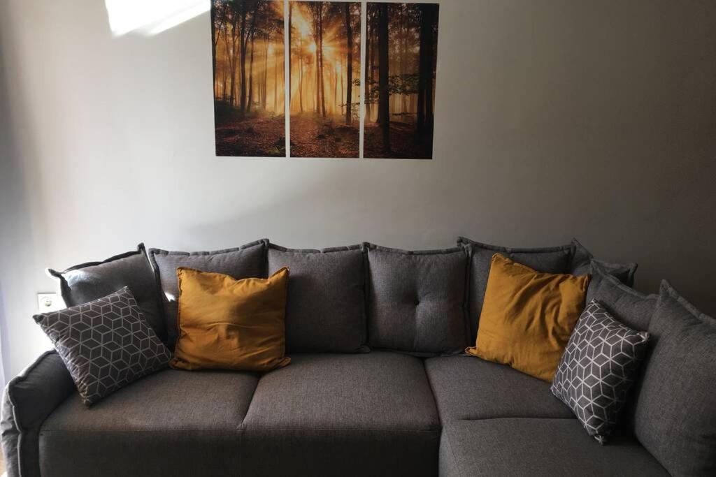 a gray couch with yellow pillows on it at Wonderful apartment at sea and golf course - Fabuloso ático con vistas al mar y campo de golf - Tolle Wohnung am Meer und Golfplatz in Almerimar