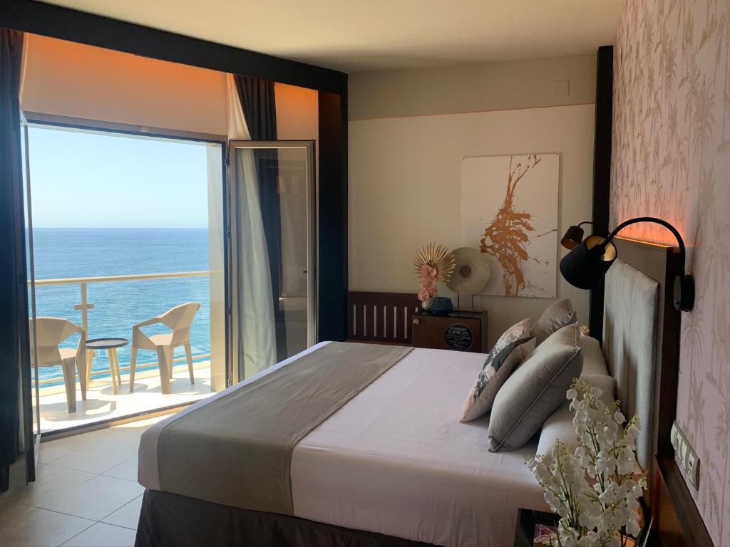 a bedroom with a bed with a view of the ocean at ON ALETA ROOM designed for adults in Almuñécar