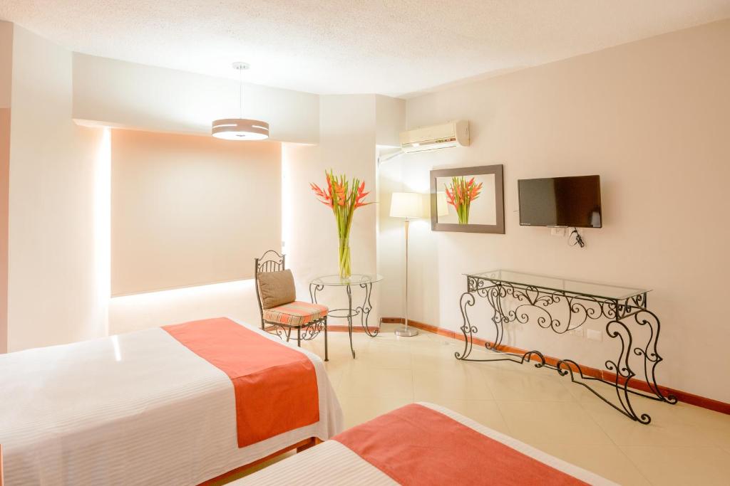 Postel nebo postele na pokoji v ubytování Hotel Loma Real