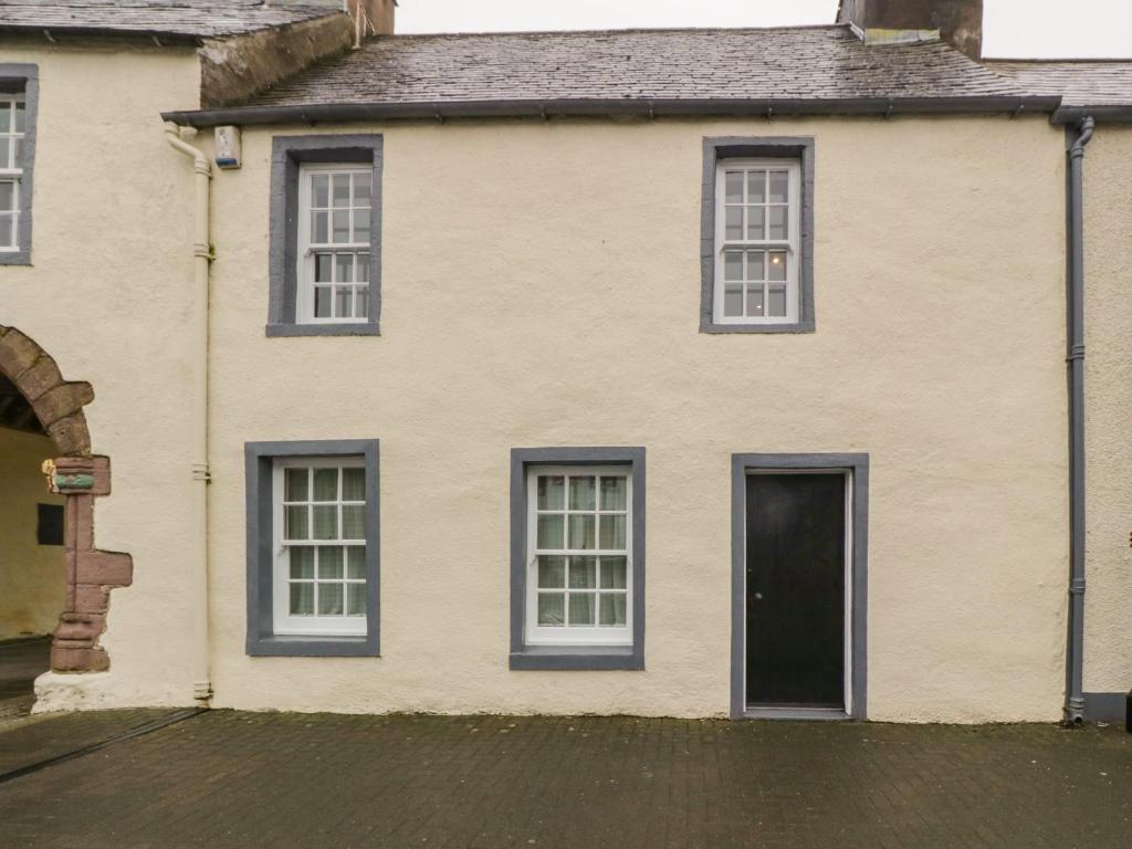 a white house with blue windows and a door at The Pend in Newton Stewart