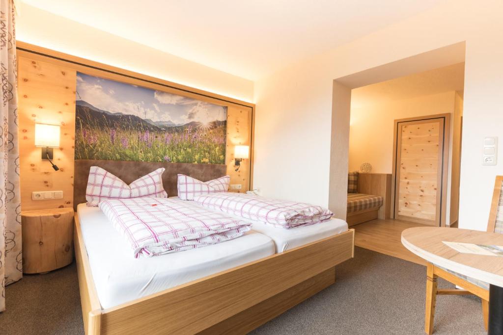 Postel nebo postele na pokoji v ubytování Hotel Garni Sonnenheim