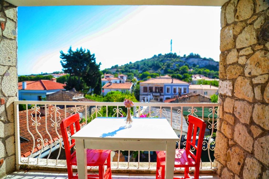 a table and chairs on a balcony with a view at Sari Gelin Alacati Hotel in Alaçatı