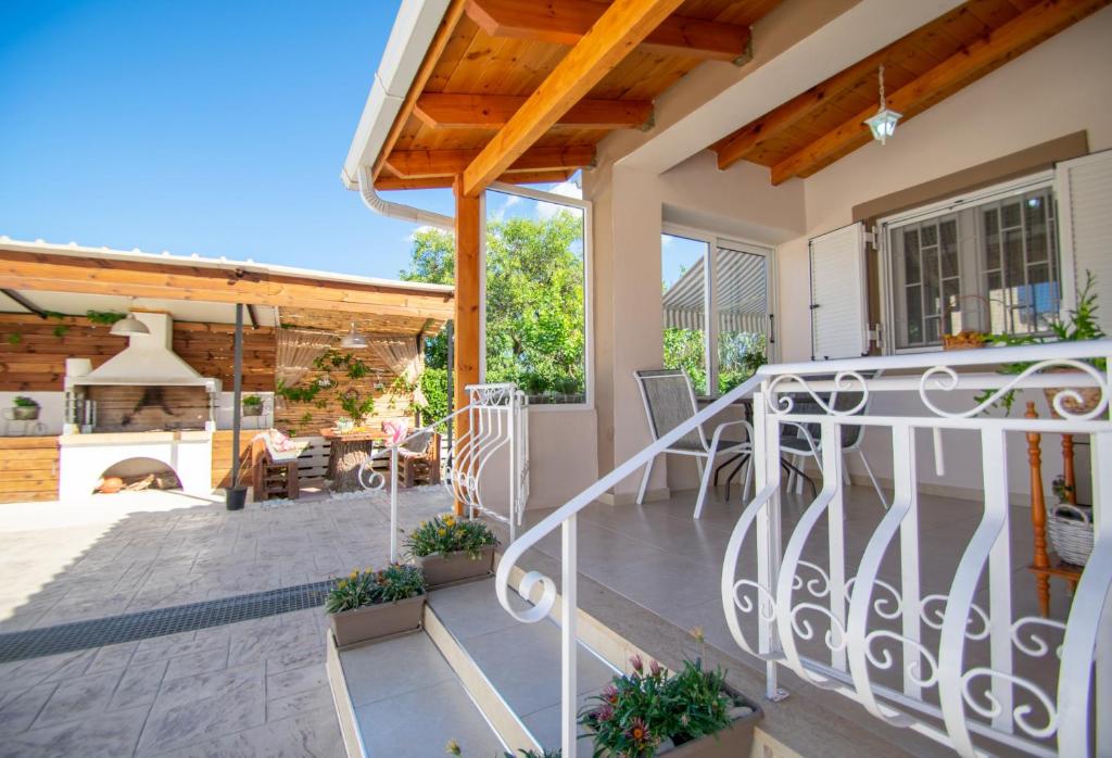 a home with a patio with a fireplace at Private Villa Bella Luna by "elite" in Zakynthos