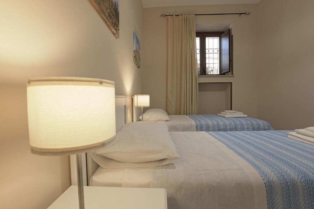 A bed or beds in a room at Zeus Atabyrios - Locazione Turistica