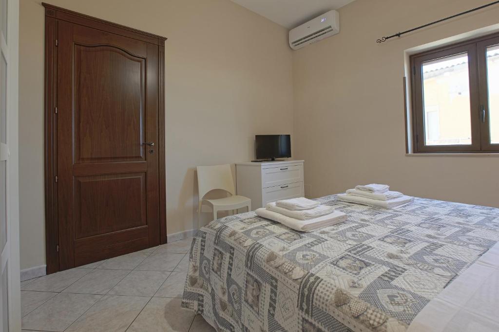 A bed or beds in a room at Zeus Atabyrios - Locazione Turistica