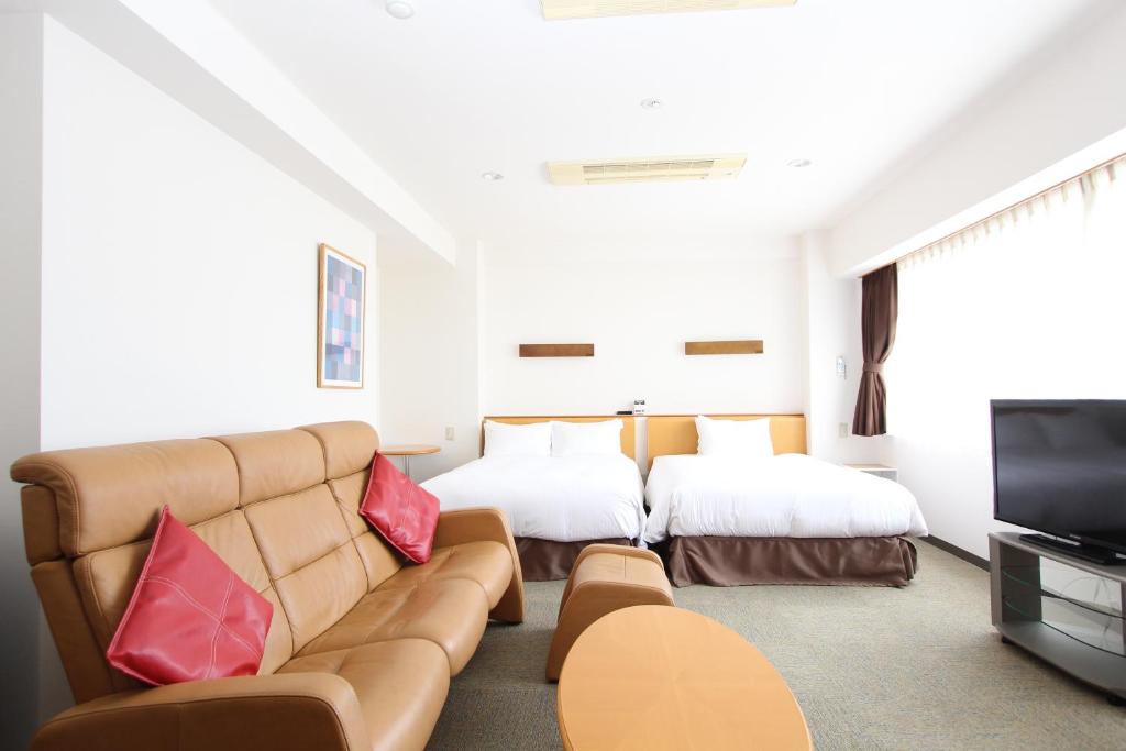 
a living room filled with furniture and a tv at Best Western Yamagata-airport in Higashine
