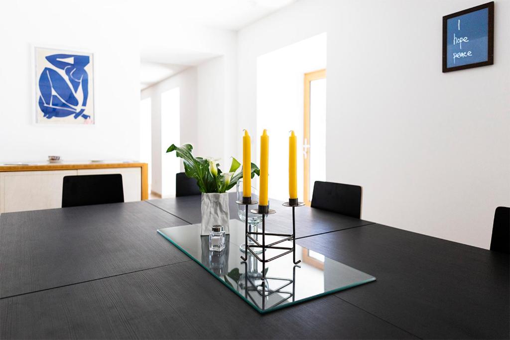 a black table with yellow candles on top of it at Rouretord La Rainette in Gilhac-et-Bruzac