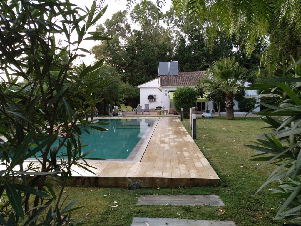 a swimming pool in the yard of a house at Chalet con Piscina - LAS ADELFAS in Chiclana de la Frontera