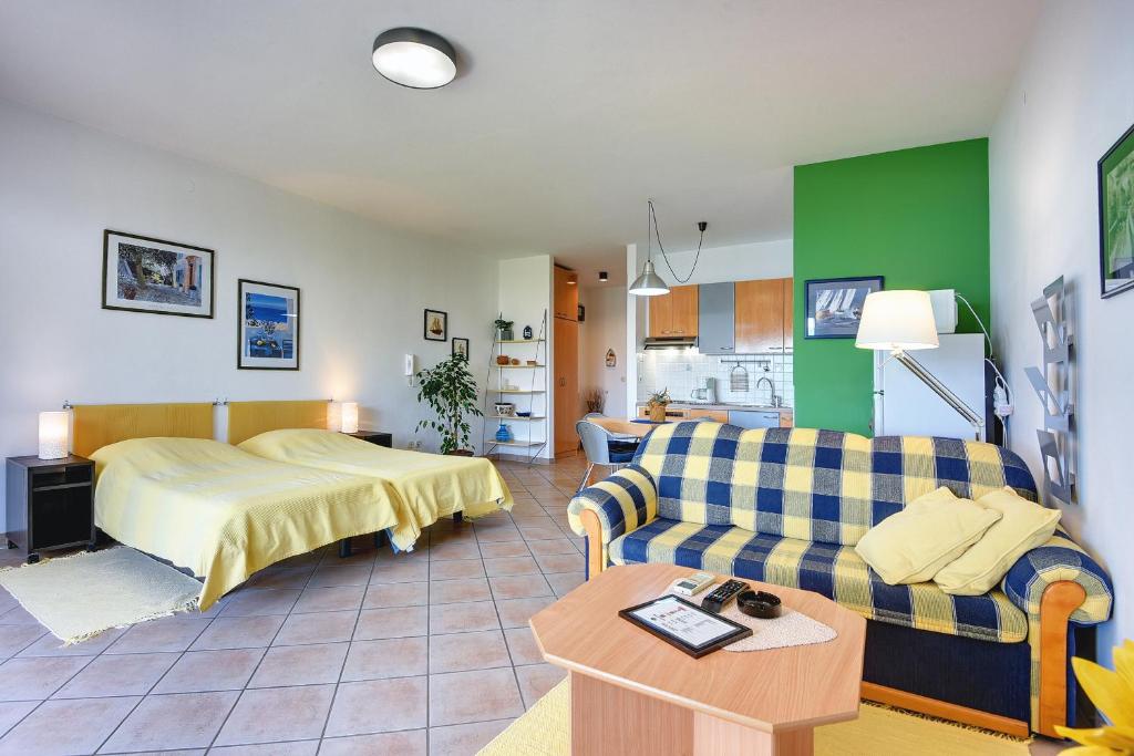 a living room with a bed and a couch at Apartments Villa Ana in Medulin