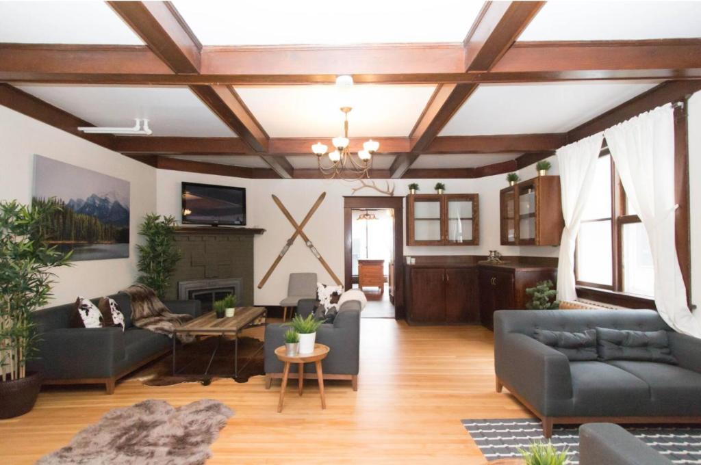 a living room with couches and a fireplace at Rocky Mountain Retreat- Enormous House Sleeps 23 in Banff