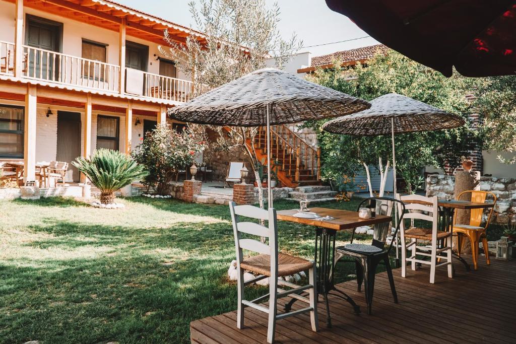 a table and chairs with umbrellas on a deck at Attalos Suites Hotel in Bergama