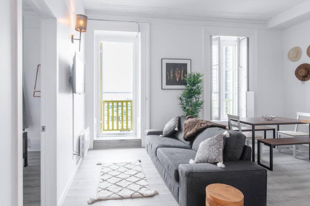 a living room with a couch and a table at Manoir des Remparts- Renovated 3 Bedroom Oasis in Quebec City