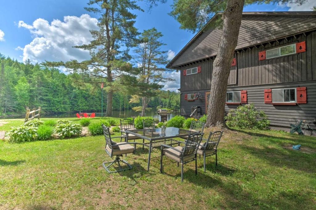 a table and chairs in front of a house at Bolton Alderbrook Lodge with Private 10-Acre Lake! in Bolton