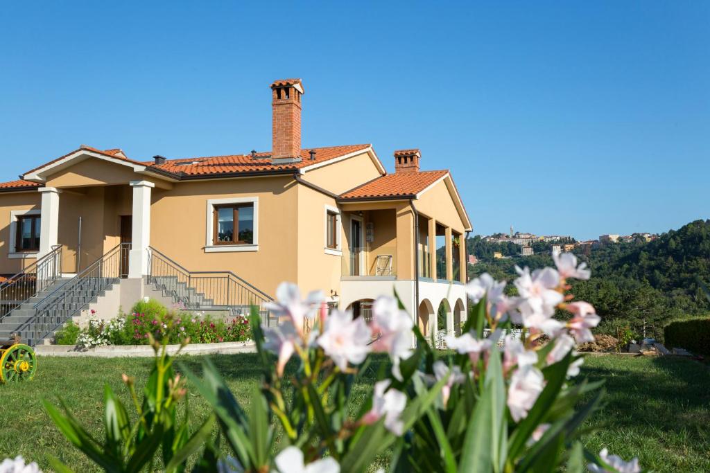 a house with flowers in front of it at Niki in Labin