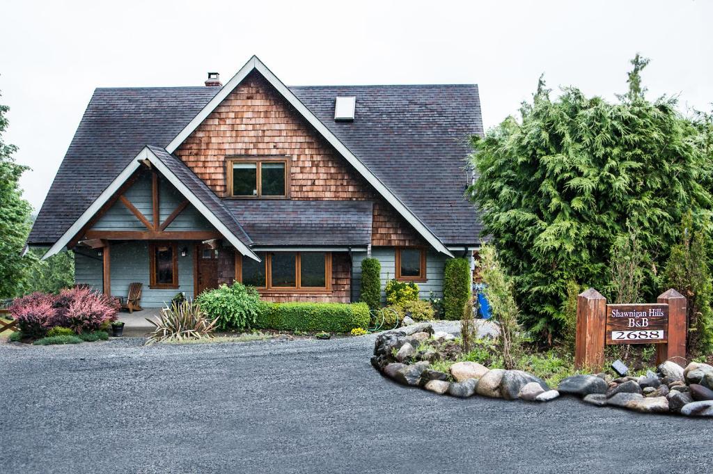 a house with a sign in front of it at Shawnigan Hills Guest Suite in Shawnigan Lake