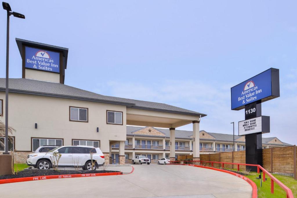 un hotel con un coche aparcado delante de él en Americas Inn & Suites IAH North en Humble