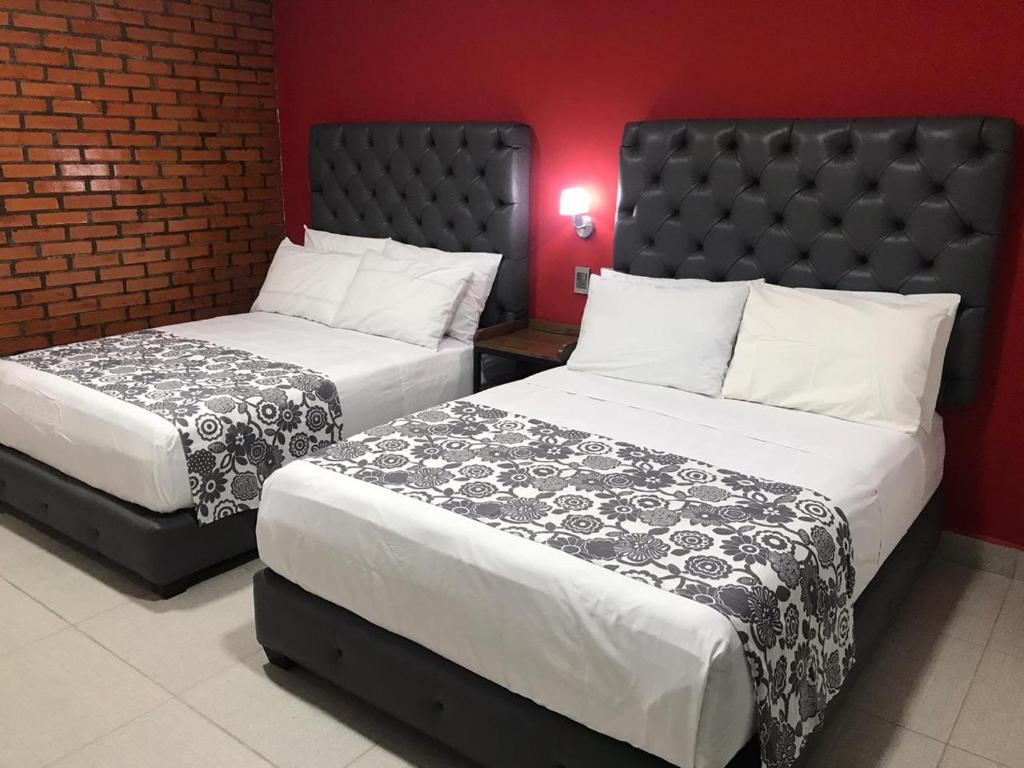Postel nebo postele na pokoji v ubytování Hotel Jar8 Acuario enfrente al Acuario de Veracruz