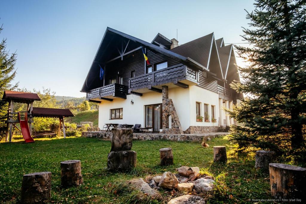 a large house with a black roof at Floarea Bucovinei in Vama