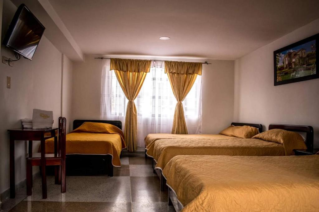 Ένα ή περισσότερα κρεβάτια σε δωμάτιο στο Hotel Venecia Confort