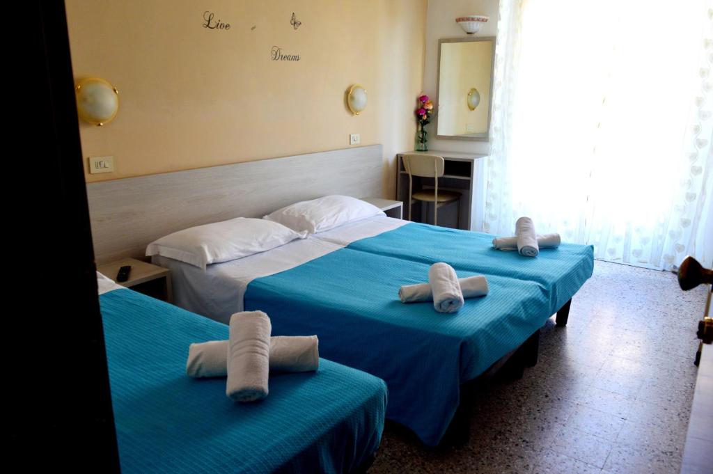 Postel nebo postele na pokoji v ubytování Hotel Cirene