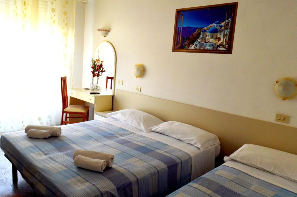 Postel nebo postele na pokoji v ubytování Hotel Cirene