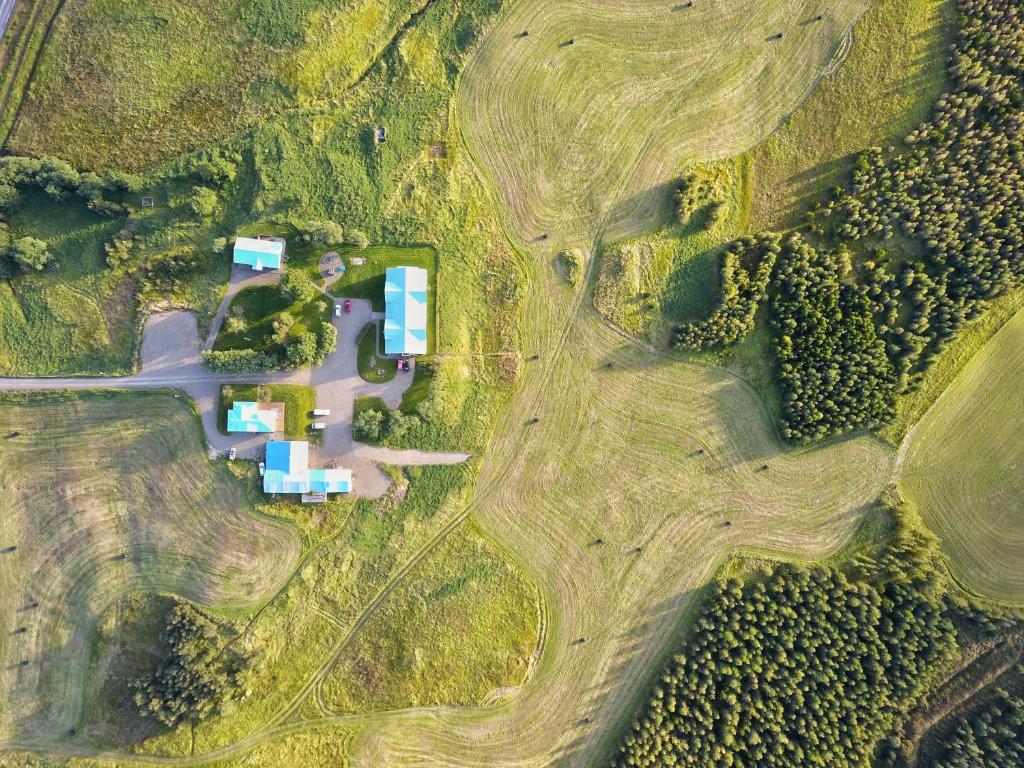 an aerial view of a house in a field at Eyjólfsstadir Guesthouse in Egilsstadir