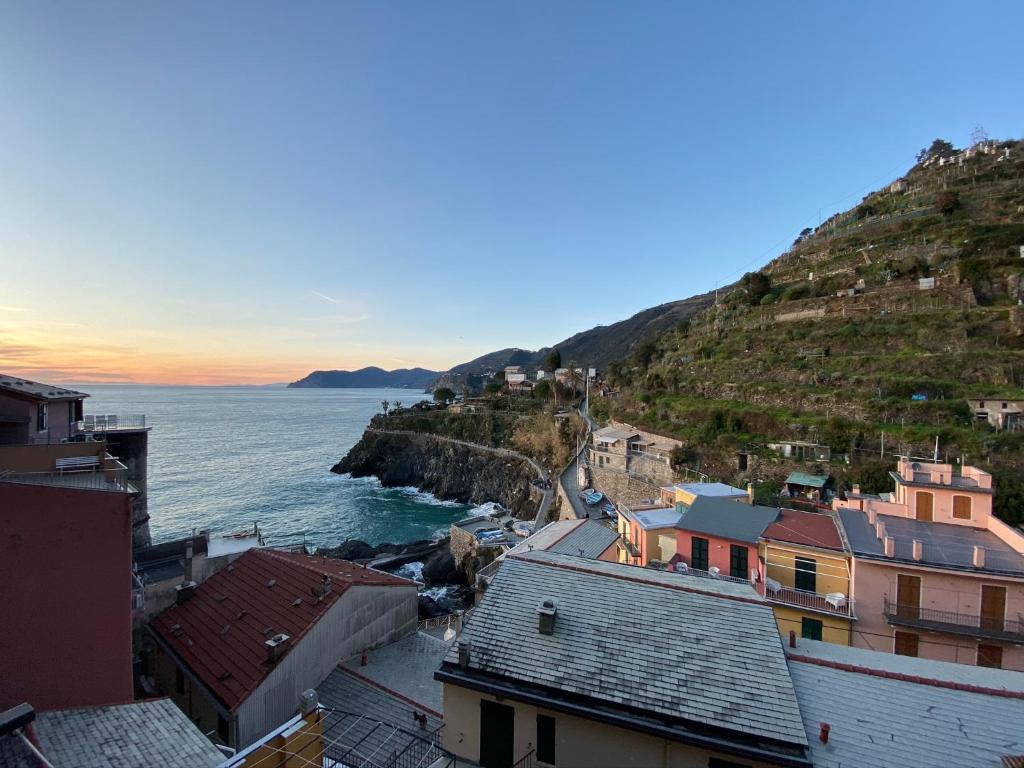 a view of the ocean from a city with houses at “Ivory house”with sea view in Manarola