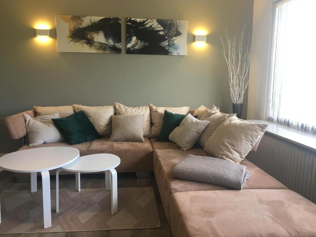 a living room with a couch and a table at One Seven - BRIGHT Collection in Koblenz