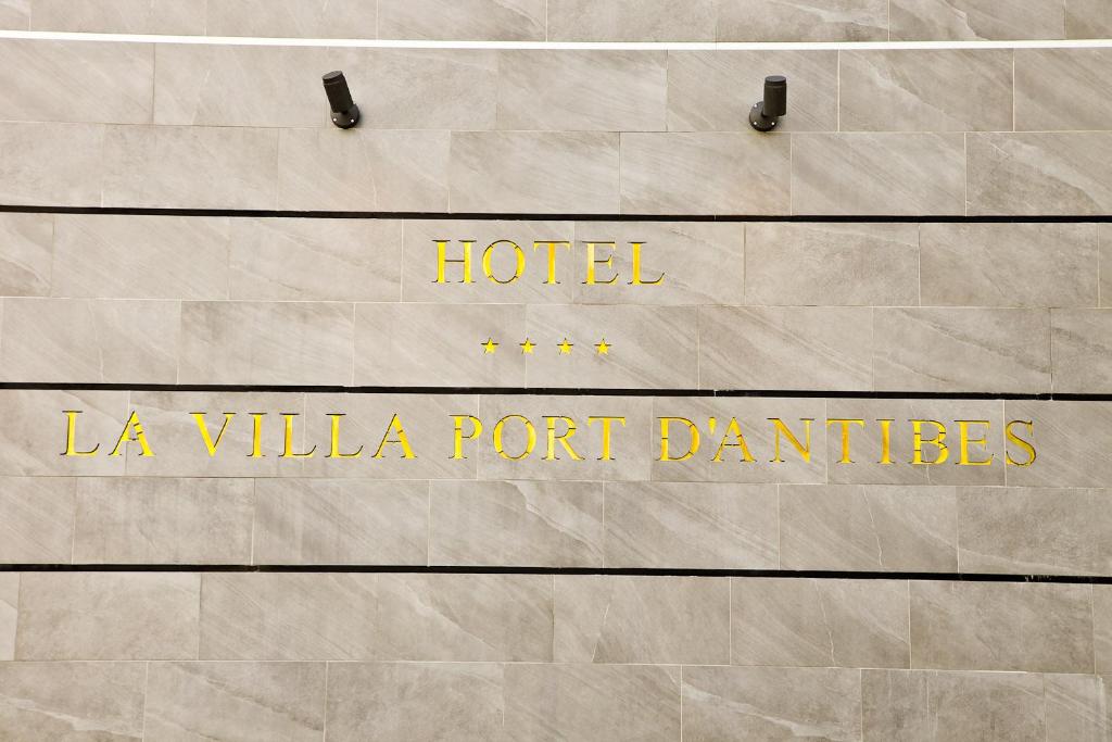 a sign that says hotel la villa port batteries at Hôtel La Villa Port d'Antibes & Spa in Antibes