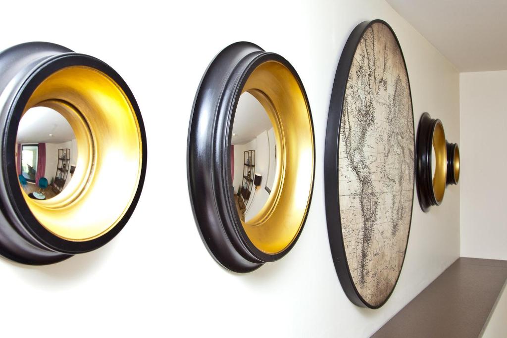 a group of three mirrors on a wall at Hôtel La Villa Port d'Antibes & Spa in Antibes