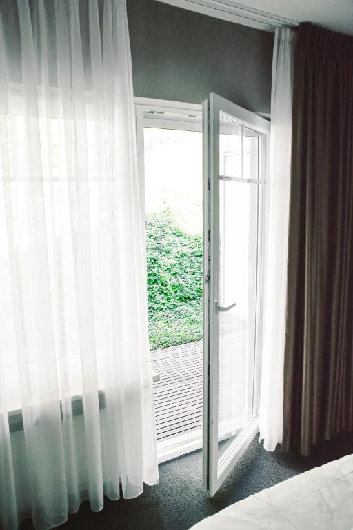 Postel nebo postele na pokoji v ubytování Parkhotel Schmallenberg