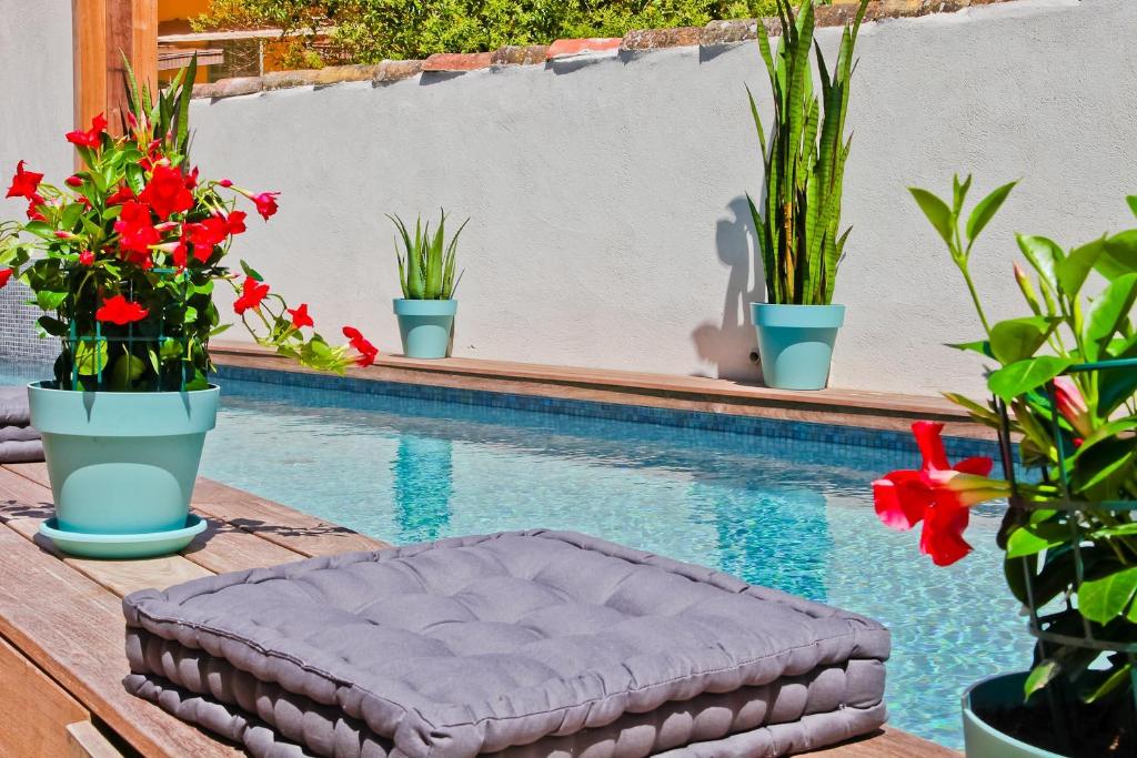 a mattress sitting on a table next to a swimming pool at Hôtel La Villa Port d'Antibes & Spa in Antibes